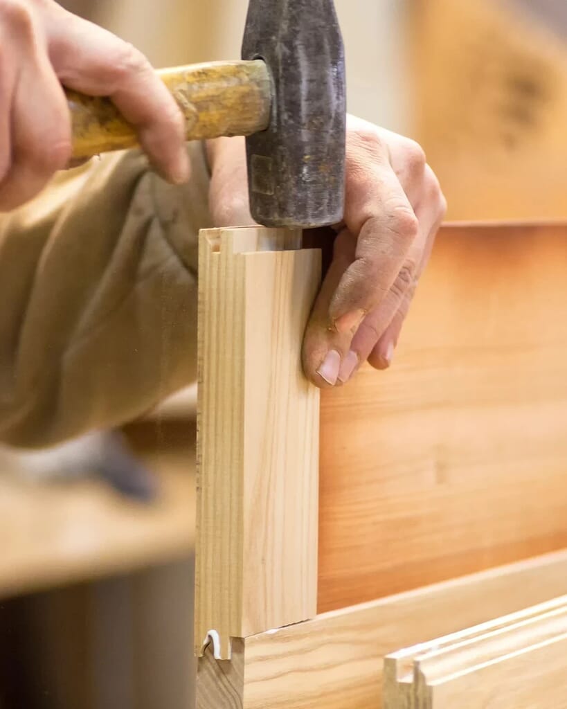 Skilled craftsmanship at ZASI factory focusing on cabinet details and precision